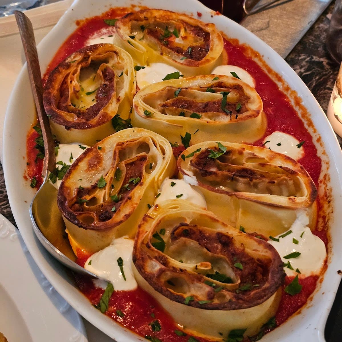 A plate of pasta on a restaurant table